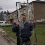 
              Oleksandr Yatsenko, 32, carries a broken window from his house destroyed by Russian shelling in Irpin, on the outskirts of Kyiv, on Thursday, April 21, 2022. Citizens of Irpin are still without electricity, water and gas after since the Russian invasion began. (AP Photo/Petros Giannakouris)
            