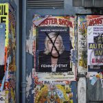 
              An electoral poster of French far-right presidential candidate Marine Le Pen with drawing on her face is displayed in Genay, outside Lyon, central France, Saturday, April 9, 2022. France's first round of the presidential election will take place on April 10, with a presidential runoff on April 24 if no candidate wins outright. (AP Photo/Laurent Cipriani)
            