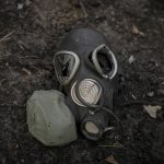 
              A damaged gas mask lies on the pavement at a Russian position which was overran by Ukrainian forces, outside Kyiv, Ukraine, Thursday, March 31, 2022. Heavy fighting raged on the outskirts of Kyiv and other zones Thursday amid indications the Kremlin is using talk of de-escalation as cover while regrouping and resupplying its forces and redeploying them for a stepped-up offensive in eastern Ukraine. (AP Photo/Vadim Ghirda)
            