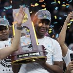 
              South Carolina's Aliyah Boston holds up the trophy after a college basketball game in the final round of the Women's Final Four NCAA tournament against UConn Sunday, April 3, 2022, in Minneapolis. South Carolina won 64-49 to win the championship. (AP Photo/Eric Gay)
            