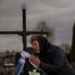 
              Galyna Bondar mourns next to the grave of her son Oleksandr, 32, after burying him at the cemetery in Bucha, in the outskirts of Kyiv, Ukraine on Saturday, April 16, 2022. Oleksandr, who joined the territorial Ukrainian defence as a co-ordinator was killed by a gunshot by the Russian Army. (AP Photo/Emilio Morenatti)
            