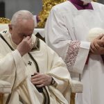 
              Pope Francis touches his face during a Chrism Mass inside St. Peter's Basilica, at the Vatican, Thursday, April 14, 2022. During the mass the Pontiff blessed a token amount of oil that will be used to administer the sacraments for the year. (AP Photo/Gregorio Borgia)
            