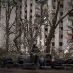 
              A Ukrainian soldier sits on tyres next to a building destroyed by Russian bombing in Chernihiv on Saturday, April 23, 2022. (AP Photo/Emilio Morenatti)
            