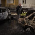 
              A man looks at his burned car after a Russian attack in Kharkiv, Ukraine, Friday, April 15, 2022. (AP Photo/Felipe Dana)
            