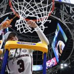 
              South Carolina's Destanni Henderson cuts the net after a college basketball game in the final round of the Women's Final Four NCAA tournament against UConn Sunday, April 3, 2022, in Minneapolis. South Carolina won 64-49 to win the championship. (AP Photo/Eric Gay)
            