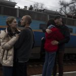 
              Vlad 27, second left, and Vlad 25, right, say goodbye to their girlfriends Elizabet 23, left, and Sofia 25 at the train station in Odesa, southern Ukraine, on Saturday, April 2, 2022. Elisabet and Sofia are fleeing the war in Ukraine to Poland. (AP Photo/Petros Giannakouris)
            