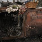 
              Flowers are placed on a Ukrainian military armored fighting vehicle destroyed during fighting between Russian and Ukrainian forces in outside Kyiv, Ukraine, Friday, April 1, 2022. Emergency relief and evacuation convoys for the besieged Ukrainian city of Mariupol remained in doubt Friday following reports of Russian interference, while Russian officials accused Ukraine of flying helicopter gunships across a border between the two countries and striking an oil depot.(AP Photo/Vadim Ghirda)
            