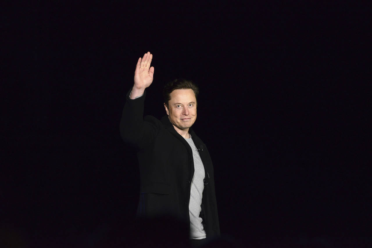 FILE - Elon Musk waves while providing an update on SpaceX's Starship, Thursday, Feb. 10, 2022, nea...