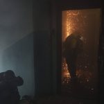 
              A firefighter opens the door of a burning apartment after a Russian bombardment in Kharkiv, Ukraine, Thursday, April 21, 2022. (AP Photo/Felipe Dana)
            