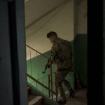 
              A Ukrainian serviceman walks inside a building after searching the apartment of a man suspected of being a Russian collaborator in Kharkiv, Ukraine, Saturday, April 23, 2022. (AP Photo/Felipe Dana)
            