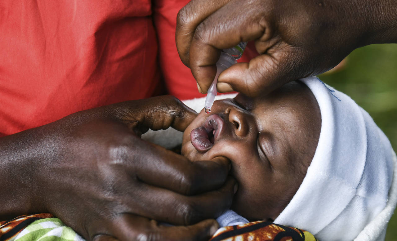 FILE - A baby receives a polio vaccine during the Malawi Polio Vaccination Campaign Launch in Lilon...