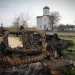 
              Fragments of a destroyed Russian military vehicle lie against the background of an Orthodox church in the village of Lypivka close to Kyiv, Ukraine, Monday, Apr. 11, 2022. Lypivka was occupied by the Russian troops at the beginning of the Russia-Ukraine war and freed recently by the Ukrainian army. (AP Photo/Efrem Lukatsky)
            