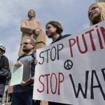 
              Demonstrators hold an anti-war poster during an anti-war and anti-Putin (Russian President Vladimir Putin) rally in Gorky Park in Bishkek, Kyrgyzstan, Saturday, March 26, 2022. (AP Photo/Vladimir Voronin)
            