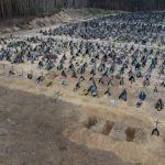
              Three dug graves are ready for the next funerals at the cemetery in Irpin, on the outskirts of Kyiv, Ukraine, Tuesday, April 19, 2022. (AP Photo/Emilio Morenatti)
            