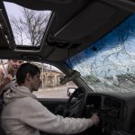 
              Oleg Tymoshenko, 23, tries to start his car almost destroyed during the war with Russia in Irpin, in the outskirts of Kyiv, Ukraine, Friday, April 15, 2022. (AP Photo/Rodrigo Abd)
            