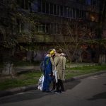 
              Three women embrace in a street in Kyiv, Ukraine on Thursday, April 28, 2022. Russia struck the Ukrainian capital of Kyiv shortly after a meeting between President Volodymyr Zelenskyy and U.N. Secretary-General Antonio Guterres on Thursday evening. (AP Photo/Emilio Morenatti)
            