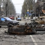 
              A part of a destroyed tank and a burned vehicle sit in an area controlled by Russian-backed separatist forces in Mariupol, Ukraine, Saturday, April 23, 2022. (AP Photo/Alexei Alexandrov)
            