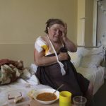 
              Tamara Oliynyk, 62, sits on a bed after surgery after being injured by shelling in Shandrigolovo village, at a hospital in Kramatorsk, eastern Ukraine, Tuesday, April 26, 2022. (AP Photo/Evgeniy Maloletka)
            