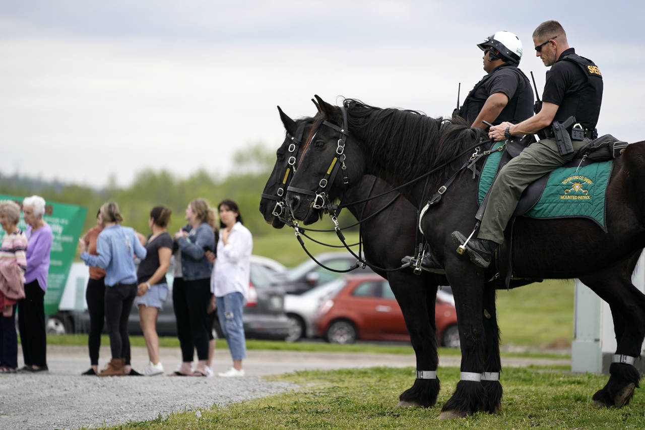 Officers on horseback guard the entrance to designated demonstrator areas near Riverbend Maximum Se...