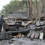 
              A local residence examines destroyed Russian tanks in the village of Dmytrivka close to Kyiv, Ukraine, Saturday, April 2, 2022. (AP Photo/Efrem Lukatsky)
            