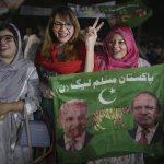 
              Supporters of newly elected Pakistani Prime Minister Shahbaz Sharif flash victory signs to celebrate outside their party's office, in Lahore, Pakistan, Monday, April 11, 2022. Pakistan's parliament elected opposition lawmaker Sharif as the new prime minister Monday, following a week of political turmoil that led to the weekend ouster of Premier Imran Khan. (AP Photo/K.M. Chaudary)
            