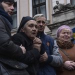 
              The mother of 40-year-old Senior lieutenant, Oliynyk Dmytro, mourns his death during his funeral ceremony, after being killed in action, outside the Holy Apostles Peter and Paul Church, in Lviv, western Ukraine, Saturday, April 2, 2022. (AP Photo/Nariman El-Mofty)
            