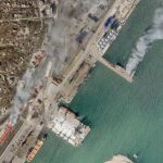 
              In this satellite photo from Planet Labs PBC, a Ukrainian naval vessel and a nearby building burn in the besieged city of Mariupol, Ukraine, Wednesday, April 6, 2022. The photo appears to show the Ukrainian command ship Donbas burning at the port in Mariupol, as a nearby building also burned around 2:30 p.m. local time Wednesday. A cause for the fire remained unclear. (Planet Labs PBC via AP)
            