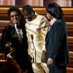 
              Dernst Emile II, center, Bruno Mars, left, and Anderson .Paak, right, of Silk Sonic accept the award for song of the year for "Leave the Door Open" at the 64th Annual Grammy Awards on Sunday, April 3, 2022, in Las Vegas. (AP Photo/Chris Pizzello)
            