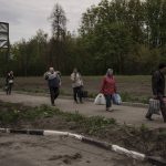 
              People fleeing the village of Ruska Lozova arrive at a screening point in Kharkiv, Ukraine, Friday, April 29, 2022. Hundreds of residents have been evacuated to Kharkiv from the nearby village that had been under Russian occupation for more than a month. (AP Photo/Felipe Dana)
            