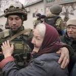 
              A woman hugs a Ukrainian serviceman after a convoy of military and aid vehicles arrived in the formerly Russian-occupied Kyiv suburb of Bucha, Ukraine, Saturday, April 2, 2022. As Russian forces pull back from Ukraine's capital region, retreating troops are creating a "catastrophic" situation for civilians by leaving mines around homes, abandoned equipment and "even the bodies of those killed," President Volodymyr Zelenskyy warned Saturday.(AP Photo/Vadim Ghirda)
            