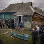 
              Relatives of Mykola Moroz, 47, gather during a funeral service at his home at the Ozera village, near Bucha, Ukraine, on Tuesday, April 26, 2022. Mykola was captured by Russian army from his house in the Ozera village on March 13, taken for several weeks in an unknown location and finally found killed with gunshots about 15 kilometres from his house. (AP Photo/Emilio Morenatti)
            