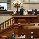 
              Ukrainian President Volodymyr Zelenskyy, on the video screen, addresses the Portuguese parliament in Lisbon, Thursday, April 21, 2022. Top right is Speaker of Parliament Augusto Santos Silva and 2nd right Portuguese President Marcelo Rebelo de Sousa. At bottom, 2nd right, is Portuguese Prime Minister Antonio Costa. (AP Photo/Armando Franca)
            