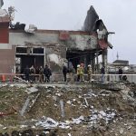 
              Emergency workers clear up debris after an airstrike hit a tire shop in the western city of Lviv, Ukraine, Monday April 18, 2022. Russian missiles hit the city of Lviv in western Ukraine on Monday, killing at least six people, Ukrainian officials said, as Moscow’s troops stepped up strikes on infrastructure in preparation for an all-out assault on the east. (AP Photo/Philip Crowther)
            