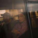 
              Kateryna Hodza, 85, and her grandson Dorschenko take a bus from a reception center for displaced people in Zaporizhzhia, Ukraine, Friday, April 29, 2022. They fled from Mala Tokmachka, in Zaporizhzhia region, as thousands of Ukrainian continue to leave Russian occupied areas. (AP Photo/Francisco Seco)
            