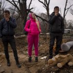 
              Residents look at their houses destroyed by a Russian bomb in Chernihiv on Friday, April 22, 2022. (AP Photo/Emilio Morenatti)
            
