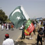 
              Supporters of ruling party Pakistan Tehreek-e-Insaf (PTI) gather during a protest in Islamabad, Pakistan, Sunday, April 3, 2022. Pakistan's embattled Prime Minister Imran Khan said Sunday he will seek early elections after sidestepping a no-confidence challenge and alleging that a conspiracy to topple his government had failed. (AP Photo/Rahmat Gul)
            