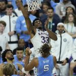 
              Kansas forward David McCormack (33) heads to the rim against North Carolina forward Armando Bacot (5) during the first half of a college basketball game in the finals of the Men's Final Four NCAA tournament, Monday, April 4, 2022, in New Orleans. (AP Photo/Gerald Herbert)
            