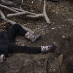 
              The body of a man lies outside his house after he was killed in Bucha, on the outskirts of Kyiv, Ukraine, Monday, April 4, 2022. Russia is facing a fresh wave of condemnation after evidence emerged of what appeared to be deliberate killings of civilians in Ukraine. (AP Photo/Felipe Dana)
            