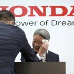 
              Honda Motor Co. Chief Executive Toshihiro Mibe wipes his face after a press conference Tuesday, April 12, 2022, in Tokyo. (AP Photo/Eugene Hoshiko)
            