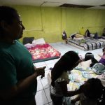 
              Iracema Figueroa, left, of Honduras, looks on as her children play with others at a shelter for migrants Friday, May 20, 2022, in Tijuana, Mexico. Figueroa has spent two years trying to reach a safe place for her family and was praying the judge would lift the order. Figueroa left Honduras in 2019 after gangs killed her uncle and threatened her three sons. (AP Photo/Gregory Bull)
            