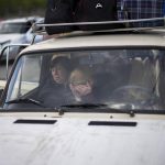 
              People wait in a car to be processed upon their arrival at a reception center for displaced people in Zaporizhzhia, Ukraine, Monday, May 2, 2022. Thousands of Ukrainian continue to leave Russian occupied areas. (AP Photo/Francisco Seco)
            