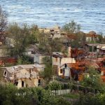 
              Heavily-damaged private houses are seen on the shore of the Sea of Azov in Mariupol, in territory under the government of the Donetsk People's Republic, eastern Ukraine, Saturday, May 21, 2022. (AP Photo/Alexei Alexandrov)
            
