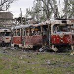 
              Destroyed trams stand in a depot in Mariupol, in territory under the government of the Donetsk People's Republic, eastern Ukraine, Saturday, May 21, 2022. (AP Photo/Alexei Alexandrov)
            