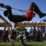 
              A Haitian migrant swings at a tourist campground in Sierra Morena, in the Villa Clara province of Cuba, Wednesday, May 25, 2022. A vessel carrying more than 800 Haitians trying to reach the United States wound up instead on the coast of central Cuba, government news media said Wednesday. (AP Photo Ramon Espinosa)
            