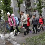 
              Women walk to clean streets in Volnovakha, in territory under the government of the Donetsk People's Republic, eastern Ukraine, Monday, May 23, 2022. (AP Photo)
            