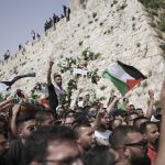 
              Mourners carry slain Al Jazeera veteran journalist Shireen Abu Akleh from her funeral in the Old City of Jerusalem to the cemetery, Friday, May 13, 2022. Abu Akleh, a Palestinian-American reporter who covered the Mideast conflict for more than 25 years, was shot dead Wednesday during an Israeli military raid in the West Bank town of Jenin. (AP Photo/Ariel Schalit)
            