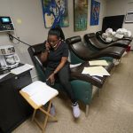 An employee talks on the phone in a recovery room inside the Hope Medical Group for Women in Shreveport, La., Friday, April 15, 2022. (AP Photo/Gerald Herbert)