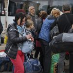 
              People board transport during an evacuation of civilians in Soledar, Donetsk region, Ukraine, Tuesday, May 24, 2022. (AP Photo/Andriy Andriyenko)
            