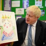 
              Britain's Prime Minister Boris Johnson holds up a portrait he painted of the Queen during a drawing session with children as part of a visit at the Field End Infant school, in South Ruislip, London, Friday May 6, 2022, following the local government elections. Britain’s governing Conservatives have suffered local election losses in their few London strongholds. Voting held Thursday for thousands of seats on more than 200 local councils decided who will oversee garbage collection and the filling of potholes, but were also seen as an important barometer of public opinion ahead of the next national election. (Daniel Leal/Pool via AP)
            