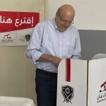 
              In this photo released by Lebanon's official government photographer Dalati Nohra, Lebanese Prime Minister Najib Mikati, right, casts his vote for Lebanon's parliamentary elections, at a polling station, in Tripoli, north Lebanon, Sunday, May 15, 2022. Lebanese voted for a new parliament Sunday against the backdrop of an economic meltdown that is transforming the country and low expectations that the voting would significantly alter the political landscape.(Dalati Nohra via AP)
            